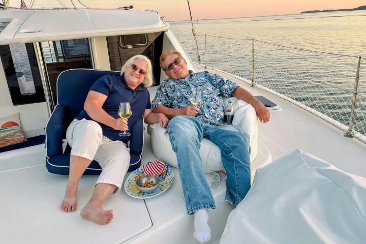 couple lounging with wine on boat