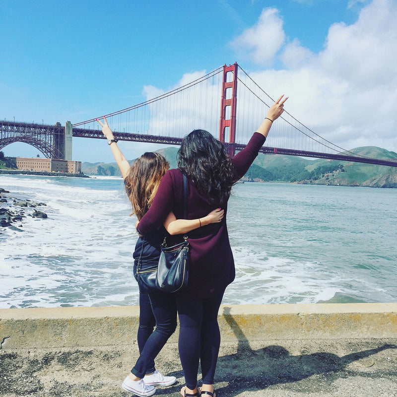 couple of people with golden gate bridge