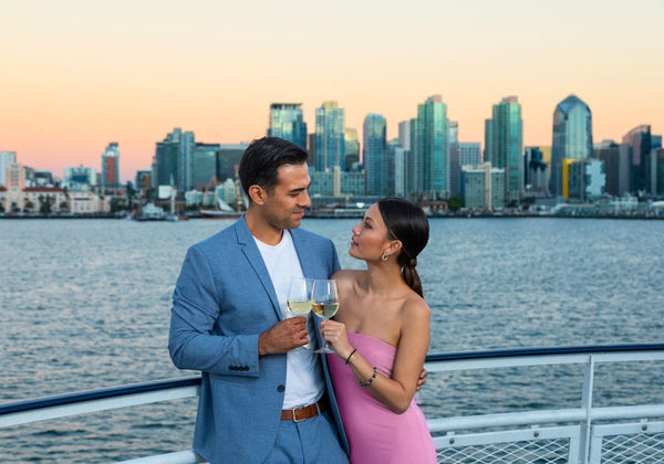 friend toasting with san diego in background at night