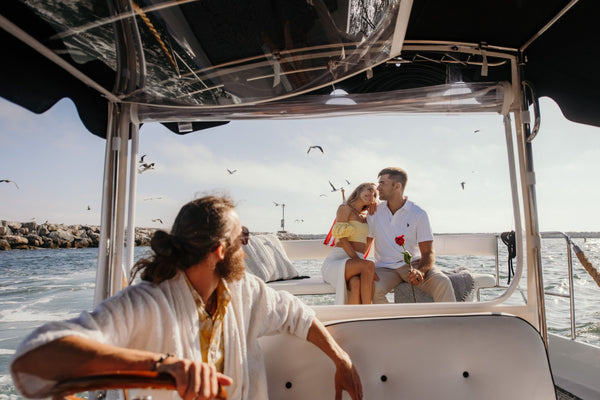 couple riding the back of a boat