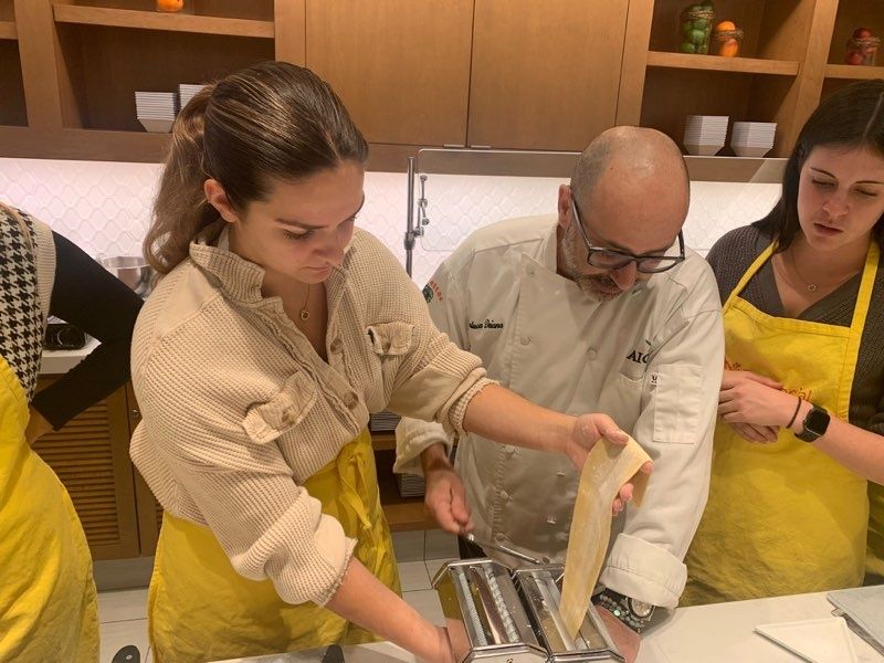 couple-rolling-pasta-through-pasta-maker
