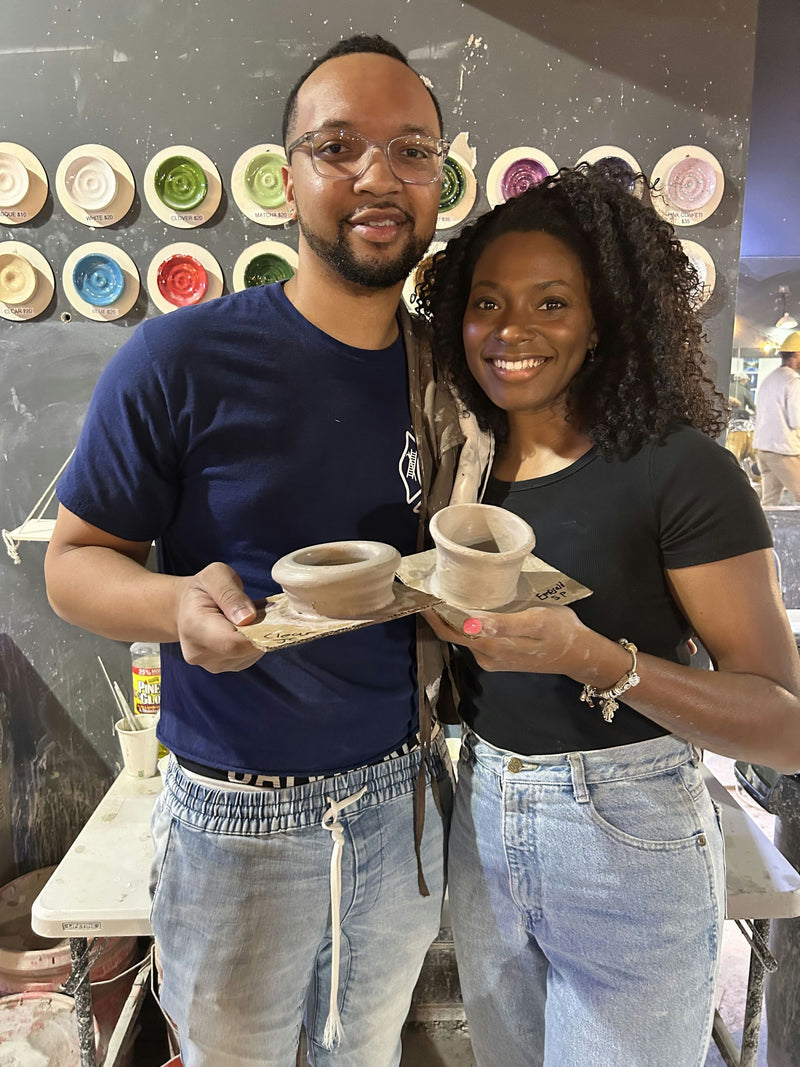 Couple showing finished pottery