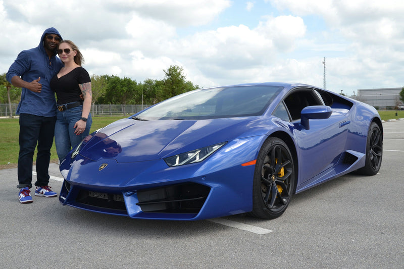 couple with blue sports car