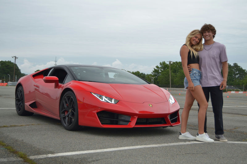 couple with red sports car