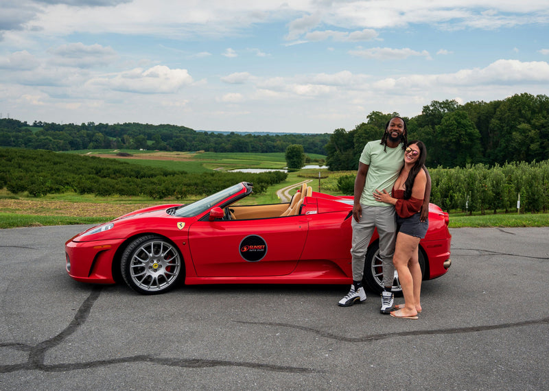 Couple with red super car