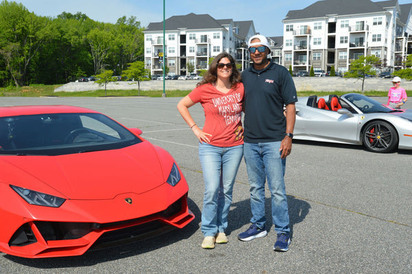 couple with red super car