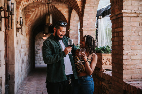 couple with wine glasses in castle