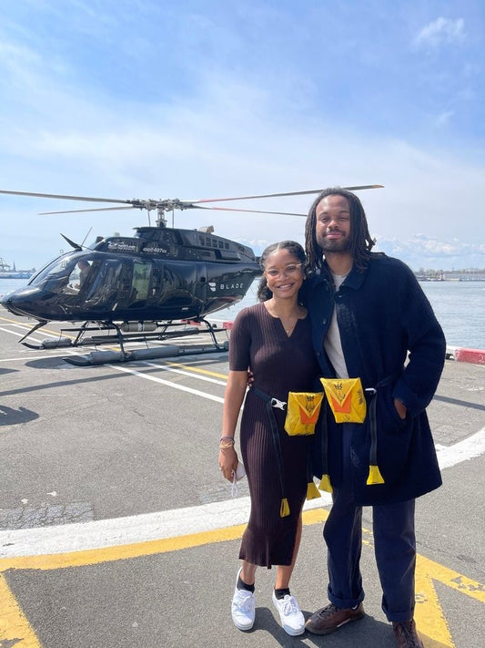 couple in front of a helicopter