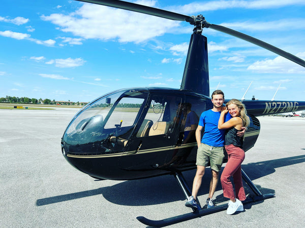 couple in front of helicopter