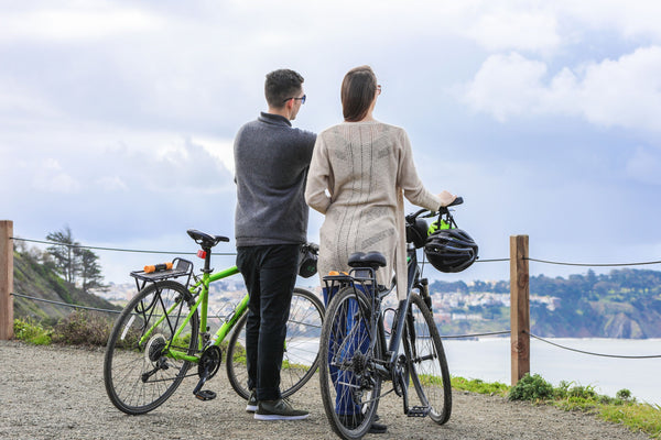 couple looking at water with bikes