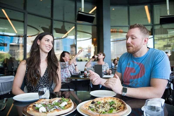 couple on a food tour in vegas eating pizza