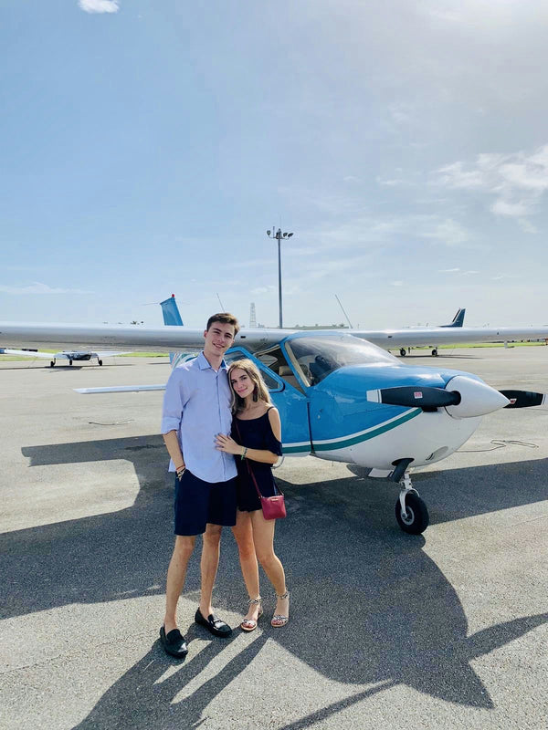 couple posed with plane