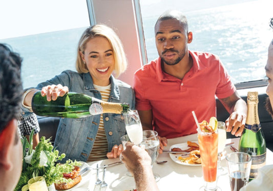 couple pouring champagne on a brunch cruise