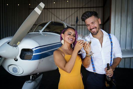 couple with champagne and plane