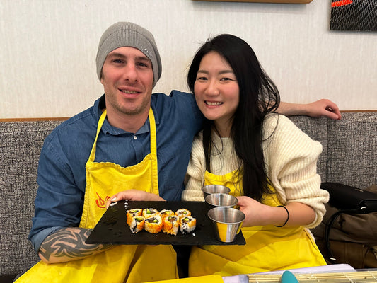 couple with final sushi plate