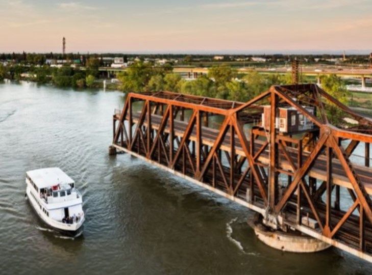 cruise-boat-going-by-a-bridge-in-sacramento