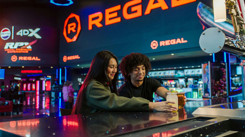 couple getting drinks at regal cinema