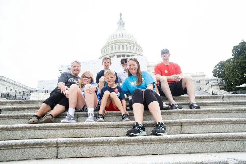 family sitting on steps in dc
