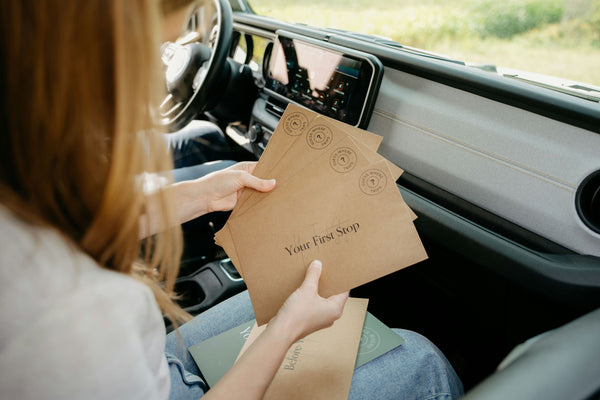 envelopes in womans hand containing clues