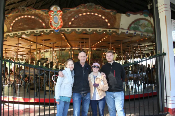 Family in fornt of merry go round.png