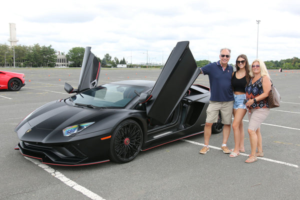 family of 3 with black car