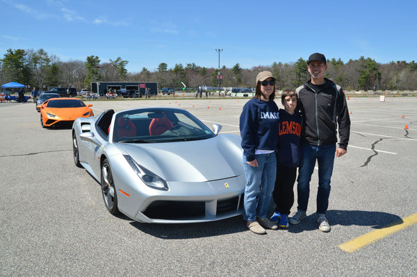 family of 3 with silver car