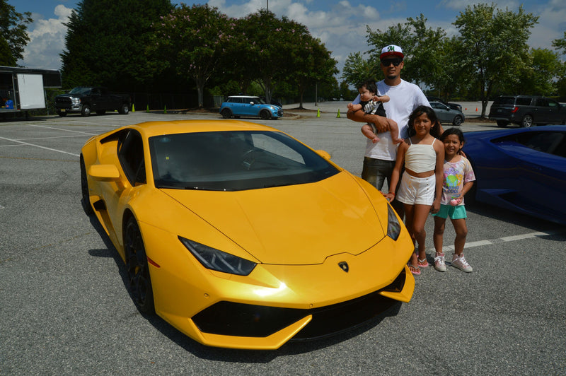 father and daughter with yellow car