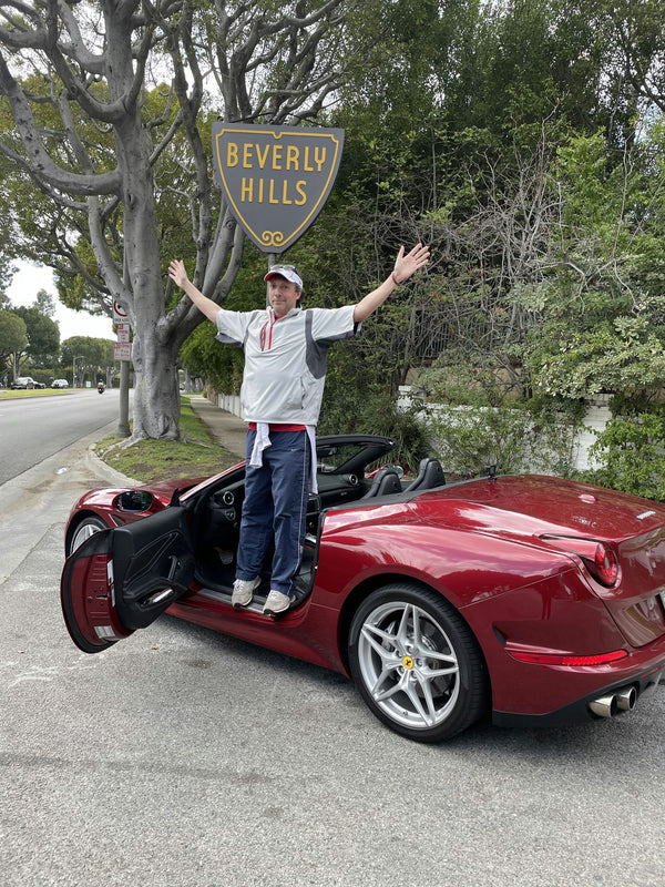 ferrari driving through beverly hills