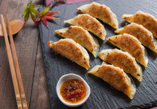 Finished dumplings on a black platter