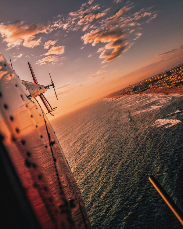 pilot flying at sunset