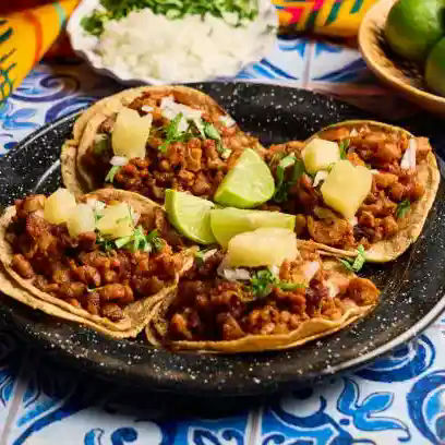 Four tacos on a plate
