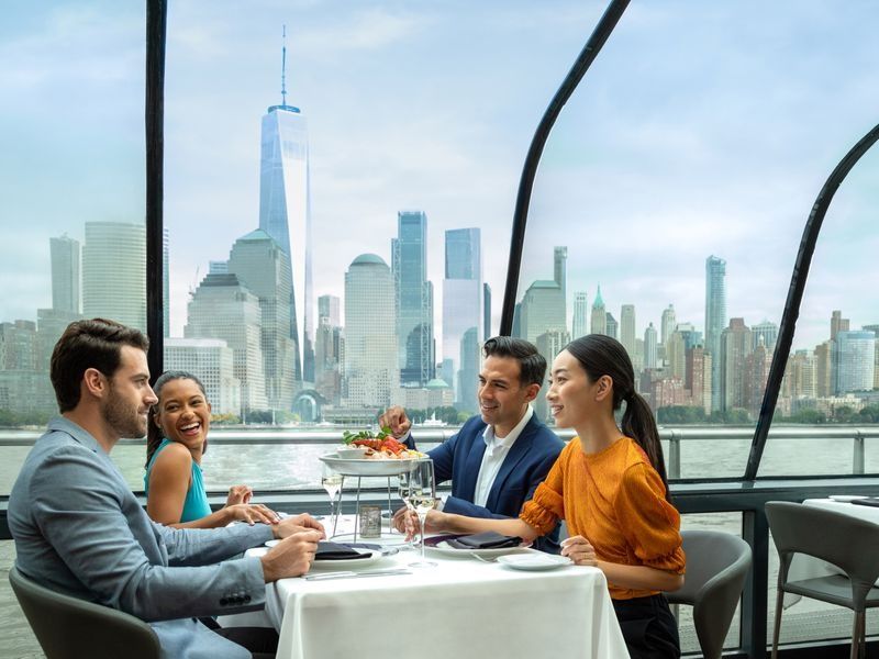 friends-on-lunch-cruise-passing-new-york-in-background