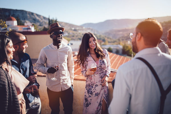friends with wine on a rooftop