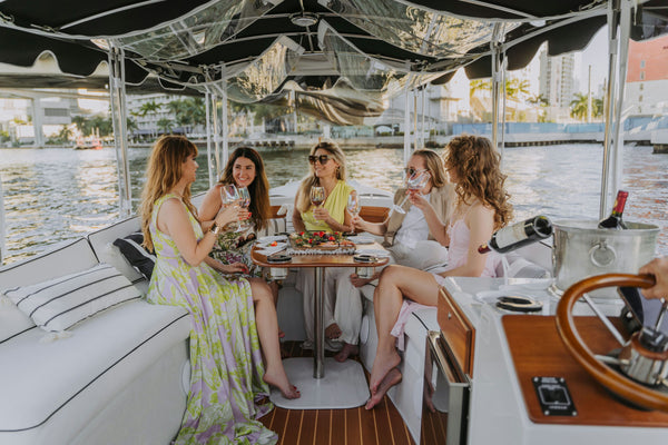 friends on a boat with wine