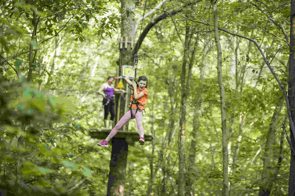girl-in-orange-shirt-on-a-zip-line