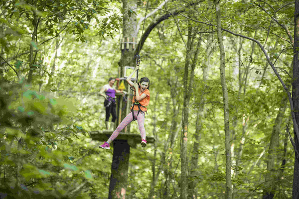 girl-in-orange-shirt-on-a-zip-line