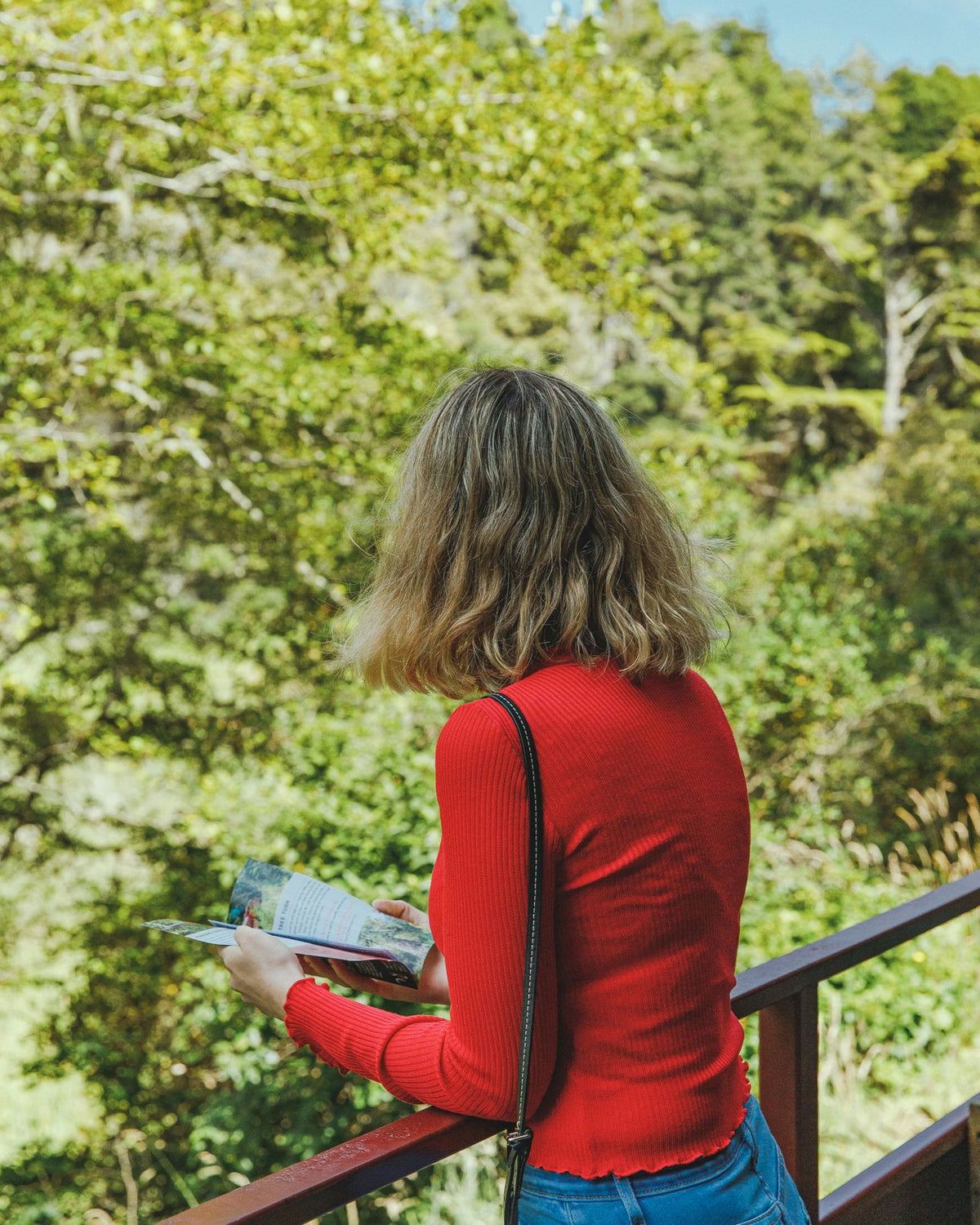 girl-looking-at-book-on-hike