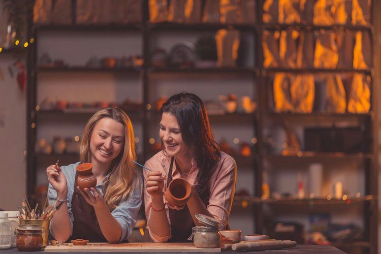girls painting vases
