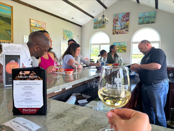 group getting wine tour near barrels