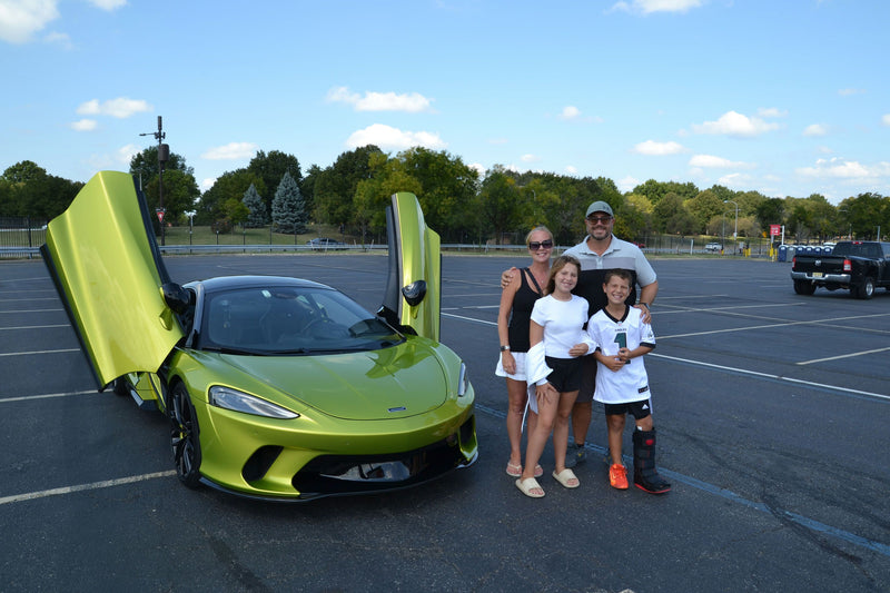 green sports car and family
