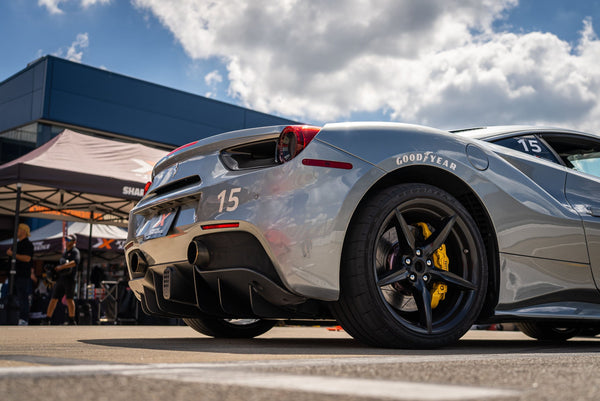 2 men with red ferrari