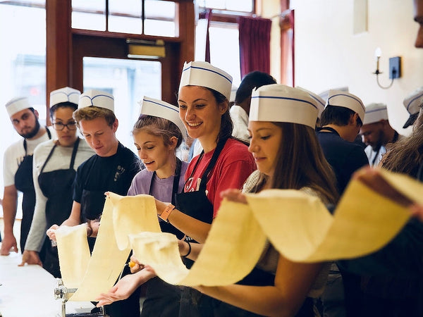 group holding long pasta