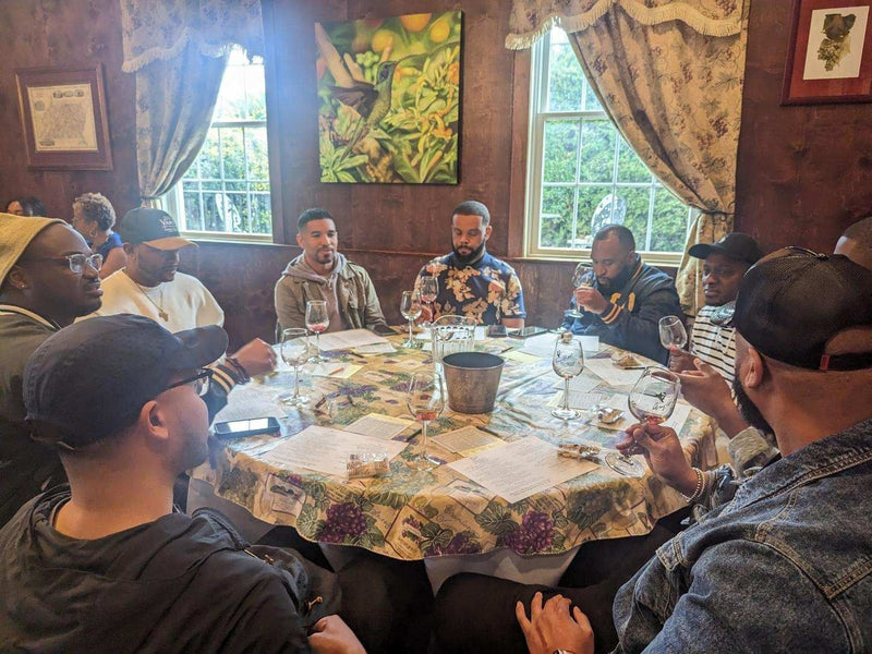 group-sitting-around-table-trying-wine