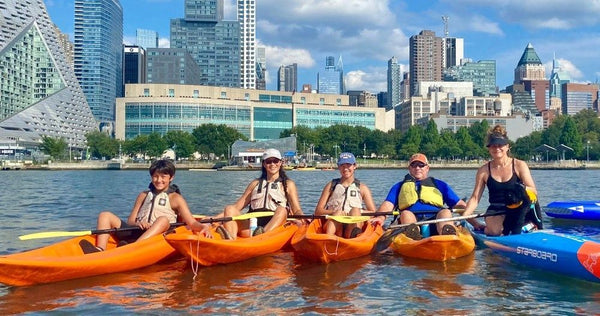 group sitting in kayaks