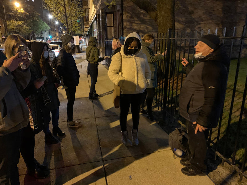 group-tour-at-night-by-fence