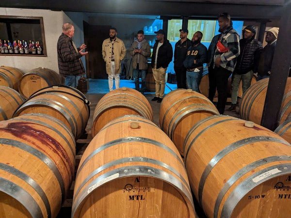 group getting wine tour near barrels