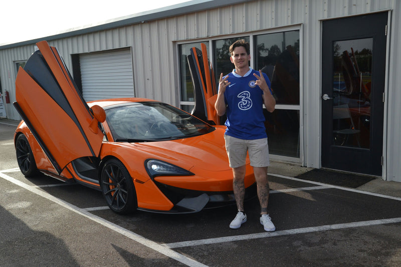 guy with orange sports car