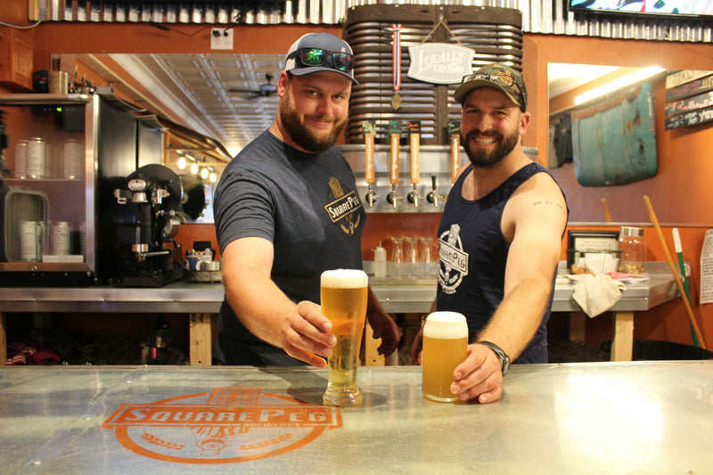 guys handing beers.jpg