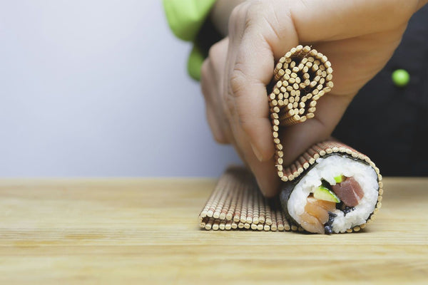 hand rolling sushi