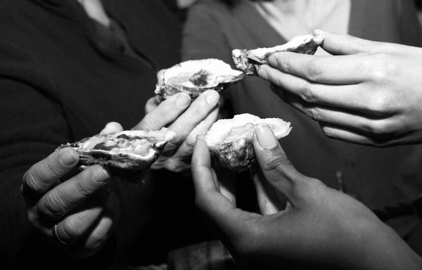 hands holding oysters
